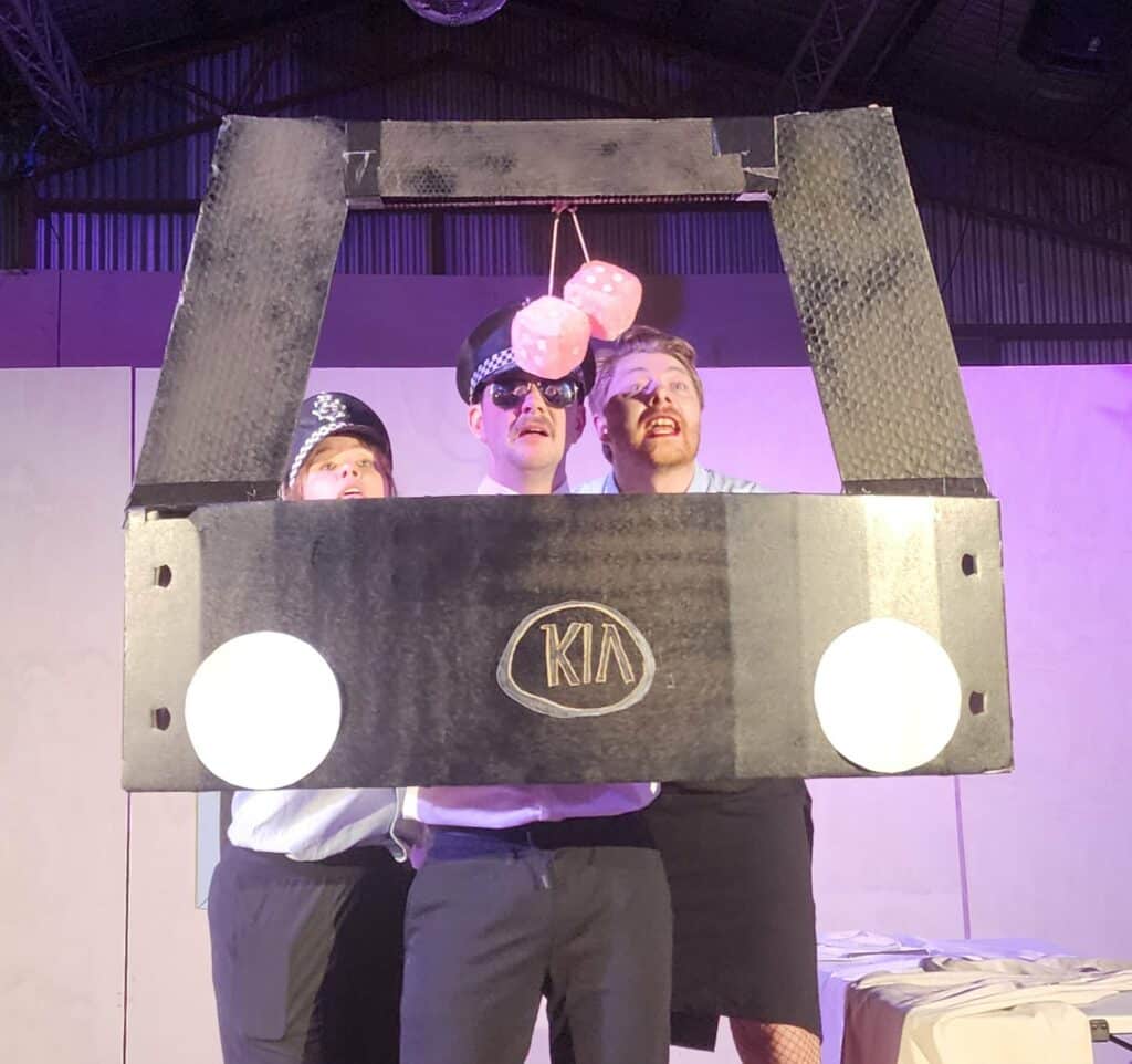 A cardboard cut out which resembles the front of a Kia car.